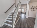 Bright entryway featuring wood floors, staircase, and modern design elements at 860 Saluda River Rd., Myrtle Beach, SC 29588