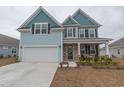 Beautiful two-story home featuring stone accents, a two-car garage, and a cozy front porch at 860 Saluda River Rd., Myrtle Beach, SC 29588