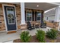 Inviting front porch with stone accents, rocking chairs, and tasteful landscaping at 860 Saluda River Rd., Myrtle Beach, SC 29588