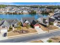 Aerial view of a red brick home nestled on a pond in a serene neighborhood at 862 Edgewater Dr., Murrells Inlet, SC 29576