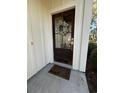 Elegant front door featuring a glass pane, decorative wreath, and a welcoming 'home' doormat at 88 Pinnacle Dr., Murrells Inlet, SC 29576