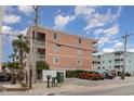 Angle view of Dunseide I building with palm trees and parking lot at 900 N Waccamaw Dr. # 305, Murrells Inlet, SC 29576