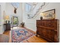 Grand two-story foyer with hardwood floors, a decorative rug, and a staircase leading to the upper level at 938 Wallace Pate Dr., Georgetown, SC 29440