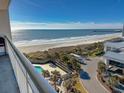 Scenic balcony view of the ocean, pool, and parking at this charming beachside resort at 9820 Queensway Blvd. # 706, Myrtle Beach, SC 29572