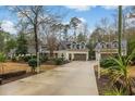 Spacious home with an extended driveway and large garage, complemented by attractive landscaping at 1 Sun Ct., Carolina Shores, NC 28467