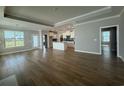 Expansive living room with hardwood floors flowing into an open-concept kitchen with a center island at 1067 Laconic Dr., Myrtle Beach, SC 29588