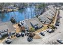 An aerial view of the condo, highlighting its proximity to the lake, parking, and manicured landscaping at 118 Gully Branch Ln. # 3, Myrtle Beach, SC 29572