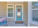 Cozy front porch with a stylish door, a welcome mat, and decorative accents at 166 New Paradise Way, Myrtle Beach, SC 29588