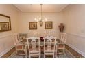 Formal dining room area featuring a glass-topped table and decorative chandelier at 2241 Waterview Dr. # 134, North Myrtle Beach, SC 29582