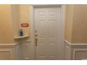 Condominium front door with white trim and gold hardware at 2241 Waterview Dr. # 134, North Myrtle Beach, SC 29582