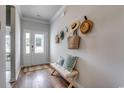 Inviting entryway with decorative hats, bench, and wood-look flooring at 327 Dunlin Pl, Conway, SC 29526