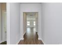 Inviting hallway with wood flooring that leads to a bright and spacious living area at 703 St. Albans Loop, Conway, SC 29526