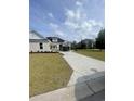 Concrete driveway leading to a lovely home with a well-maintained lawn in a desirable neighborhood at 740 Jade Dr., Myrtle Beach, SC 29579