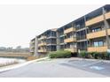 Exterior view of multi-story condo building with multiple balconies and parking spaces available at 9501 Shore Dr. # A309, Myrtle Beach, SC 29572