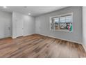 Bright bedroom featuring wood-look floors, neutral paint, and a large window with views of the construction at 1018 Laconic Dr., Myrtle Beach, SC 29588