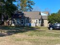 Spacious backyard featuring a well-maintained lawn and a cozy back porch at 1061 Valley Dr., Calabash, NC 28467