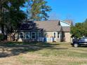 Expansive backyard featuring a well-maintained lawn and a charming back porch at 1061 Valley Dr., Calabash, NC 28467