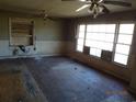 Spacious living room with hardwood floors, large windows, and ceiling fans at 12 E Sassafras St., Andrews, SC 29510