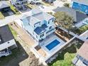 Aerial view of a two-story house with a private rectangular pool in the backyard with a fence at 128 Seabreeze Dr., Murrells Inlet, SC 29576