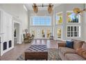 Bright and airy living room boasts soaring ceilings, large windows and doors, and tile floors at 128 Waterway Crossing Ct., Little River, SC 29566