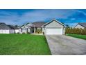 Attractive one-story home with green lawn, concrete driveway, and attached garage at 130 Maiden Ln., Myrtle Beach, SC 29588