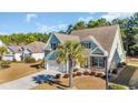 An aerial view of a well-maintained home with a beautiful lawn and mature trees at 132 Summerlight Dr., Murrells Inlet, SC 29576