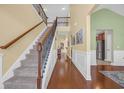 Spacious foyer featuring hardwood floors, staircase with rod iron, and a view into other rooms at 132 Summerlight Dr., Murrells Inlet, SC 29576