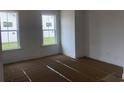 Bright bedroom with two large windows, white walls, and clean trim, ready for personalization at 147 Joyce Dr, Longs, SC 29568