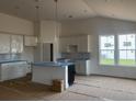 Modern kitchen with white cabinets, an island, and pendant lighting, blending style and functionality at 147 Joyce Dr, Longs, SC 29568