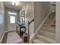 Bright foyer with hardwood floors, staircase, decor, and natural light streaming through the front door at 153A Parmelee Dr. # A, Murrells Inlet, SC 29576