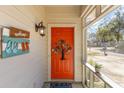 Inviting front porch with a brightly colored door, decorative wreath, and charming welcome decor at 17 Racquet Club Dr., Pawleys Island, SC 29585