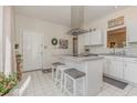 Bright kitchen featuring white cabinets, a central island with seating, and modern appliances at 17 Racquet Club Dr., Pawleys Island, SC 29585