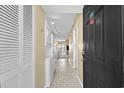 Hallway view featuring white tile flooring and washer and dryer at 1709 S Ocean Blvd. # 510, North Myrtle Beach, SC 29582