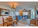 Comfortable living room with tile floors, ceiling fan, ocean view, and adjacent dining area at 1903 S Ocean Blvd. # 701, North Myrtle Beach, SC 29582