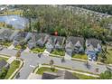 An aerial view of a cozy neighborhood featuring well-maintained homes and mature trees near a serene lake at 2122 Silver Spring Ln., Myrtle Beach, SC 29577