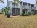 Backyard view shows screened in porch, privacy fence, mature trees, and room to entertain at 219 Salt Marsh Circle # 14A, Pawleys Island, SC 29585