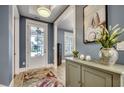 Inviting foyer with wood flooring, white trim, statement art, and view to living area at 2381 Tidewatch Way, North Myrtle Beach, SC 29582