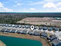 Scenic aerial view of a residential community featuring well-maintained homes, a pond, and lush green spaces at 2408 Blue Crane Circle, Myrtle Beach, SC 29577