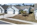 Inviting single-Gathering home with a two-car garage, blue siding, and mature palm tree in the front yard at 2408 Blue Crane Circle, Myrtle Beach, SC 29577