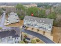 A birds eye view of the townhouse complex surrounded by mature trees and a manicured golf course at 2557 Pete Dye Dr. # 702, North Myrtle Beach, SC 29582