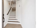 Inviting entryway featuring a bright staircase with modern wood railings and durable wood-look flooring at 2557 Pete Dye Dr. # 702, North Myrtle Beach, SC 29582