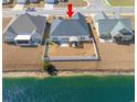 Aerial view of the home featuring a fenced backyard backing onto a scenic pond at 257 Leste Rd., Myrtle Beach, SC 29588