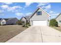 Charming single-story home with a two-car garage and well-maintained landscaping at 2960 Tigers Eye Rd., Little River, SC 29566