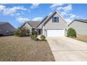 Charming single-story home with a two-car garage and well-maintained landscaping at 2960 Tigers Eye Rd., Little River, SC 29566