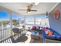 Cozy screened porch features comfortable seating, ceiling fan, and neighborhood views at 308 24Th Ave. N, North Myrtle Beach, SC 29582