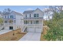 Two-story home boasts a double garage, covered porch, and a bright, modern facade with inviting curb appeal at 319 Crossing Ct., Myrtle Beach, SC 29588