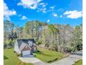 Aerial view of a two-story brick home with a long driveway, surrounded by lush trees and landscaping at 359 Rose Ave., Georgetown, SC 29440