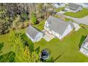 Aerial view of a home with a detached garage, a large yard, patio area, and trampoline at 359 Rose Ave., Georgetown, SC 29440