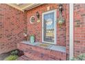 Inviting front porch with brick accents, a decorative glass door, and charming curb appeal at 359 Rose Ave., Georgetown, SC 29440