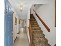 Bright hallway with tile flooring, staircase, and view to the living area at 401 10Th Ave. S # C-3, Myrtle Beach, SC 29577